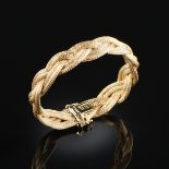 AN 18K YELLOW GOLD GUCCI BRACELET, the double rope braided design with hidden push-button box