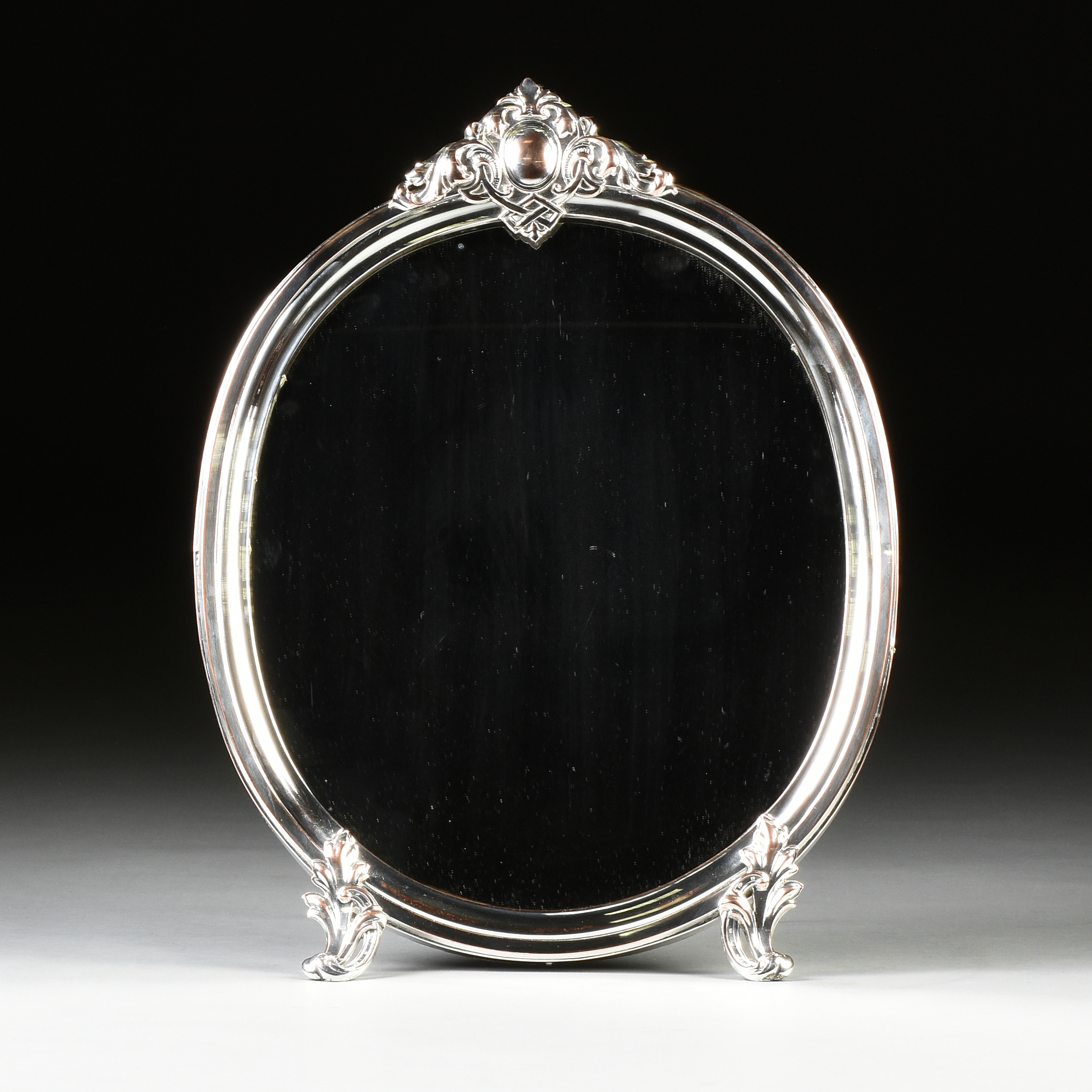 A ROCOCO REVIVAL SILVERPLATED TABLE TOP MIRROR, POSSIBLY ENGLISH, LATE 19TH CENTURY, the oval