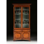 A GEORGE III STYLE CARVED ELM BOOKCASE CABINET, EARLY 20TH CENTURY, with a rectangular molded