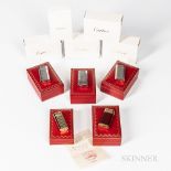 Five Cartier "Briquets" Lighters, all with original inner and outer boxes and paperwork, including a