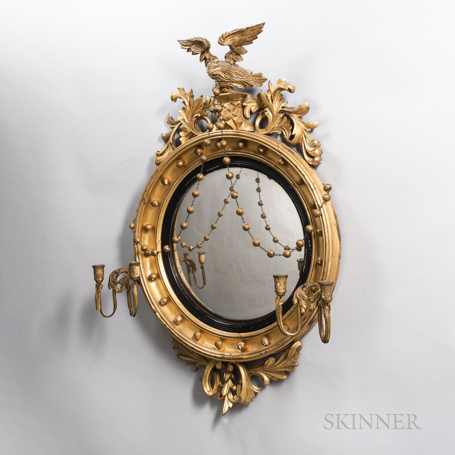 Neoclassical Giltwood Convex Mirror, with an eagle crest supporting pendant swags, with a pair of lo