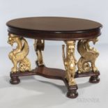 Parcel-gilt Mahogany Center Table, oval top raised on gilded griffins joined by a lower stretcher on