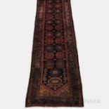 Malayer Runner, Iran, c. 1920, featuring a dark blue field with stylized palmettes, 14 ft. 2 in. x 3
