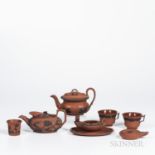 Seven Wedgwood Rosso Antico Items, England, 19th century, each with applied black basalt relief, inc