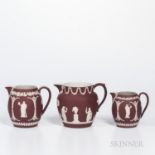 Three Wedgwood Crimson Jasper Dip Jugs, England, early 20th century, each with applied white classic