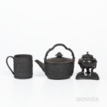 Three Wedgwood Black Basalt Items, England, 19th century, a cylindrical mug with wide oak leaf band,