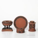 Four Wedgwood Rosso Antico Items, England, 19th century, each with applied black basalt relief, a ci