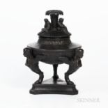 Wedgwood Black Basalt Tripod Urn and Cover, England, 19th century, fluted cover with three seated Sy