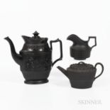 Three Black Basalt Tea Wares, England, 19th century, a marked Wedgwood basketweave engine-turned tea