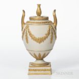 Wedgwood Gilded White Stoneware Vase and Cover, England, 19th century, urn finial and upturned loop