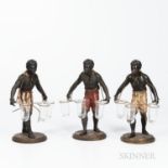 Three Blackamoor Table Figures, 19th century, each painted metal with variously painted breeches, an