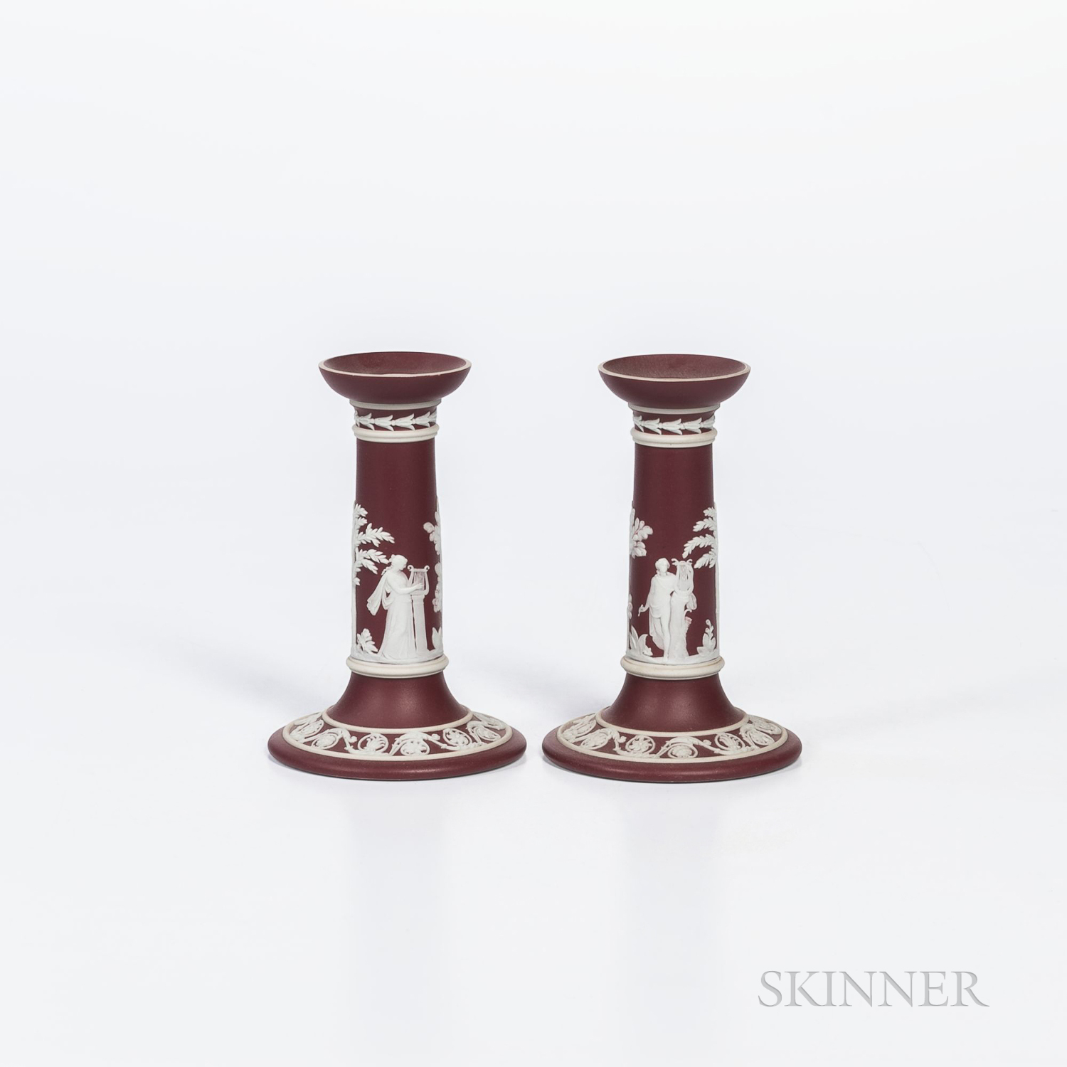 Pair of Wedgwood Crimson Jasper Dip Candlesticks, England, early 20th century, applied white classic