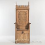Gothic-style Carved Oak Armchair, late 19th/early 20th century, with carved tracery panels and a hin