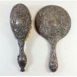 A silver backed dressing table mirror and brush