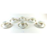 A set of six German cups and saucers with floral swag decoration