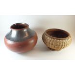 A large African pottery grain bowl, and a similar wicker bound bowl