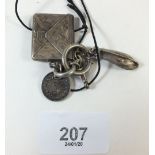 A silver envelope form stamp case with two white metal charms