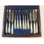 A silver plated and mother of pearl fruit cutlery set - twelve place settings in mahogany case