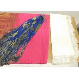 A Chinese red silk tasselled shawl, a blue and gold one and a cream one (stained)