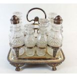 A 19th century cut glass and silver topped cruet set on a silver plated stand