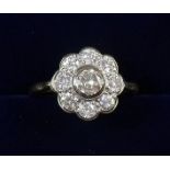 An 18 carat gold diamond cluster ring - size J