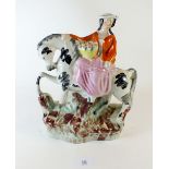 A Victorian Staffordshire equestrian figure of a lady with basket of fruit