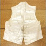 An early 20th century cream silk gentlemans waistcoat with foliage decoration