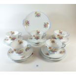 A Shelley floral printed vintage tea service comprising five cups and saucers, six tea plates, and