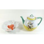 A continental teapot decorated birds and a lobster frilled entre dish