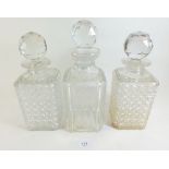 A pair of square shaped cut glass decanters together with one similar - tallest 26.5cm
