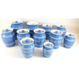 A collection of eleven vintage blue glazed labelled kitchen storage jars - one lid missing