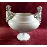 A large porcelain centrepiece bowl with bisque cherubs to shoulders - 32cm tall