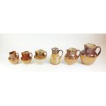 A collection of six Royal Doulton stoneware jugs