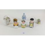 A novelty porcelain set of three figurative cruet bottles - lids a/f and one with hairline crack