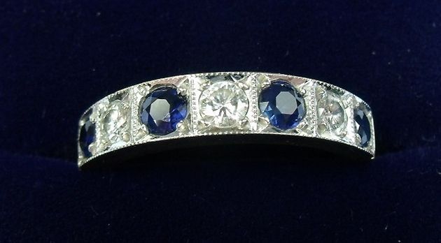An 18 carat gold half eternity ring set sapphires and diamonds, size P