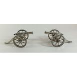 A pair of miniature silver plated model cannons, 15cm long