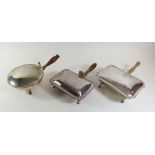 Three silver plated food warmers with turned wooden handles and claw or pad feet, (one by Garrards)