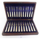 A silver fruit cutlery set with twelve knives and forks and ivory handles, Sheffield 1936, in