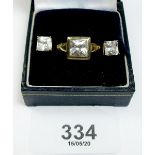 A 9 carat gold ring set square crystal - size L, and a pair of matching earrings