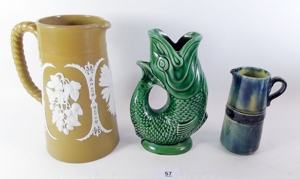 An Adams brown stoneware jug with applied vine decoration, a Dartmouth fish jug and a blue Studio