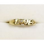 An 18 carat gold ring 'Love' inset diamond - size N