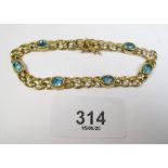 A 9 carat gold bracelet set blue topaz - 1 stone re-set back to front - 11.5 grams.