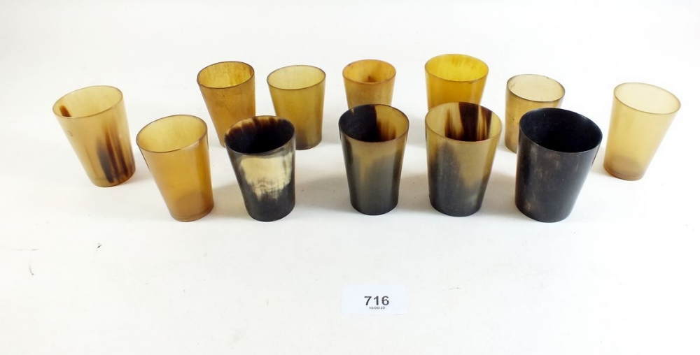 Twelve small horn tumblers.