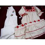 Two Mexican embroidered children's dresses, a crochet edged dress and one other dress