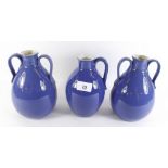 A pair of Royal Doulton blue stoneware two handled jugs together with a similar Doulton single
