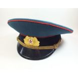 A USSR military peak cap with enamel cap badge