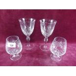 Four cut glass wine glasses and five brandy glasses