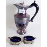 A silver plated hot water jug and a pair of silver plated cruets