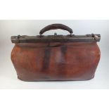 A vintage leather Gladstone bag