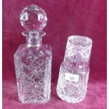 A cut glass spirit decanter and a carafe with glass